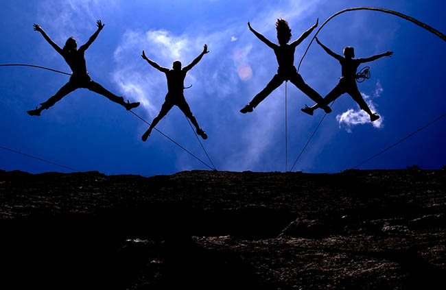 Jackson Hole, Wyoming, USA Project Bandaloop Aerial Dancers perform a high-flying aerial dance suspended by ropes on Rodeo Wall near Jackson Hole, Wyoming.