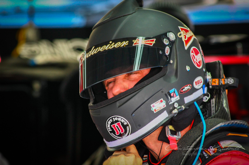 Kevin Harvick putting on his helmet.