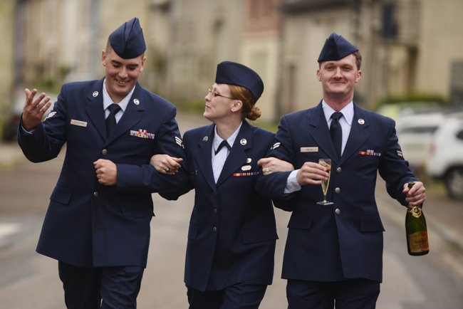 From left to right, U.S. Air Force A1C Bonnie Burks, Senior Airman Aaron Dickerson, A1C Josiah Austin, from Ramstein Air Base, Germany walk to their bus after a reception following the American Memorial Day Ceremony at the Meuse-Argonne American Cemetery and Memorial, France. A large group of Airmen from Ramstein Air Base, Germany volunteered to participate in the ceremony held Sunday morning. Joshua L. DeMotts/Stars and Stripes