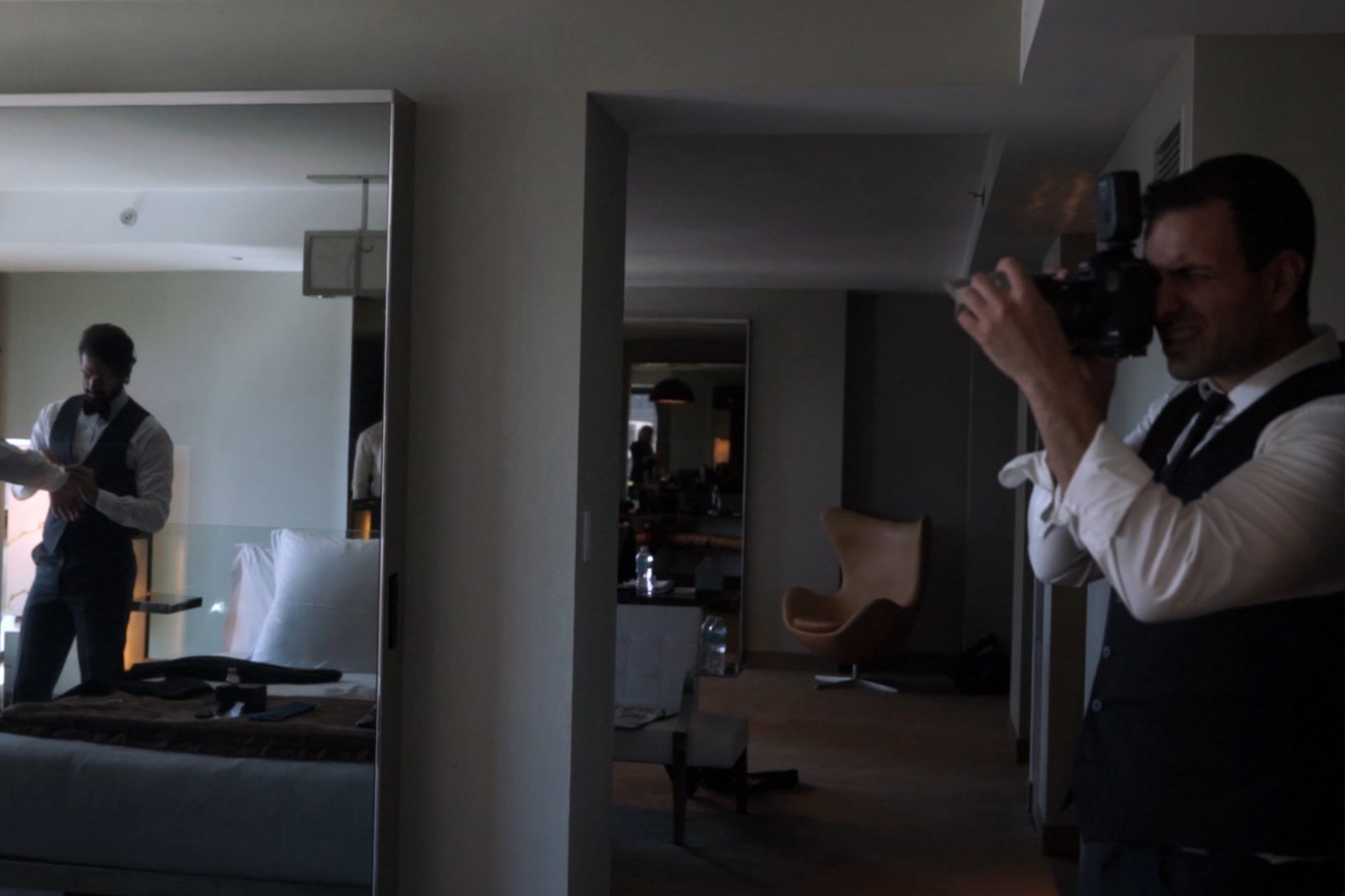 Photographer demonstrating how to hold triangular prism against camera lens