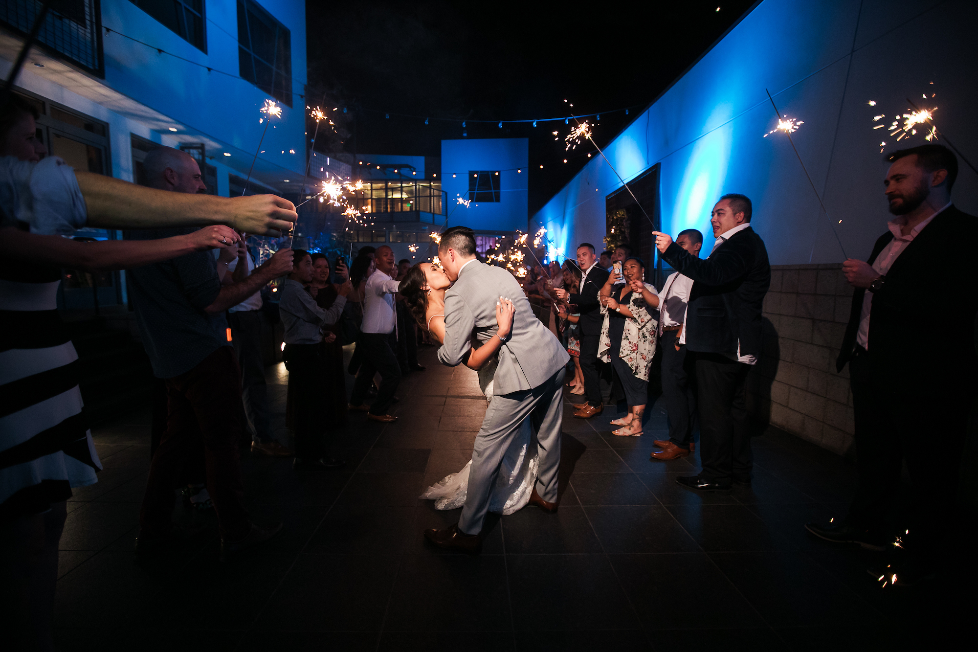 couple dips for a kiss in photos of sparklers