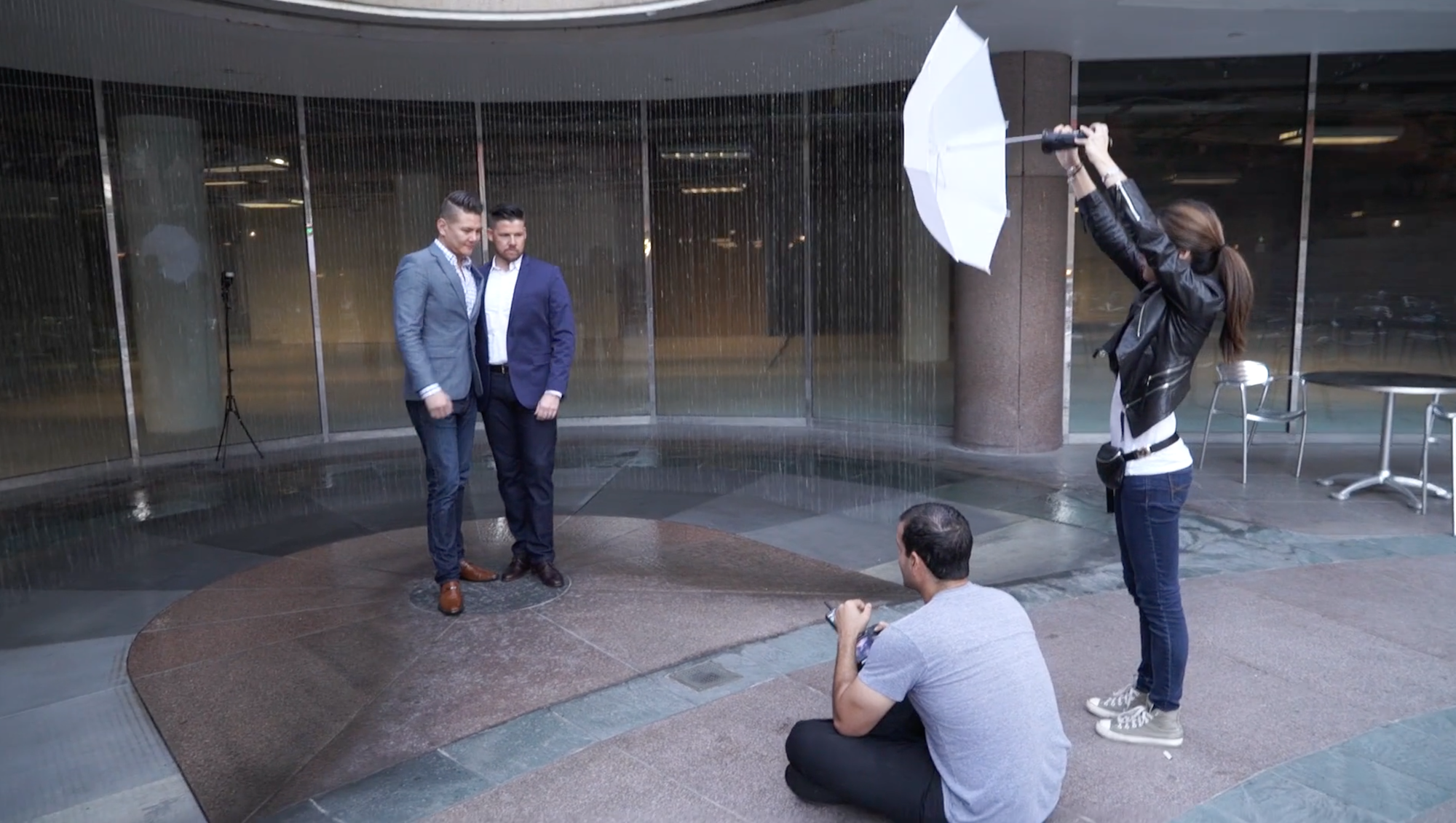 Lighting assistant holding a reflector during a wedding portrait session