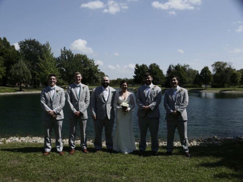 A terrible wedding photo of the groom, groomsmen, and bride.