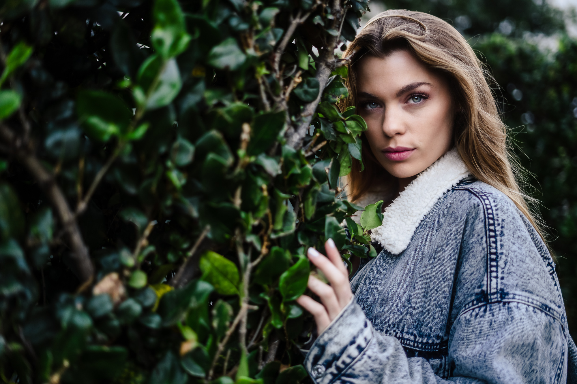 Girl next to a bush