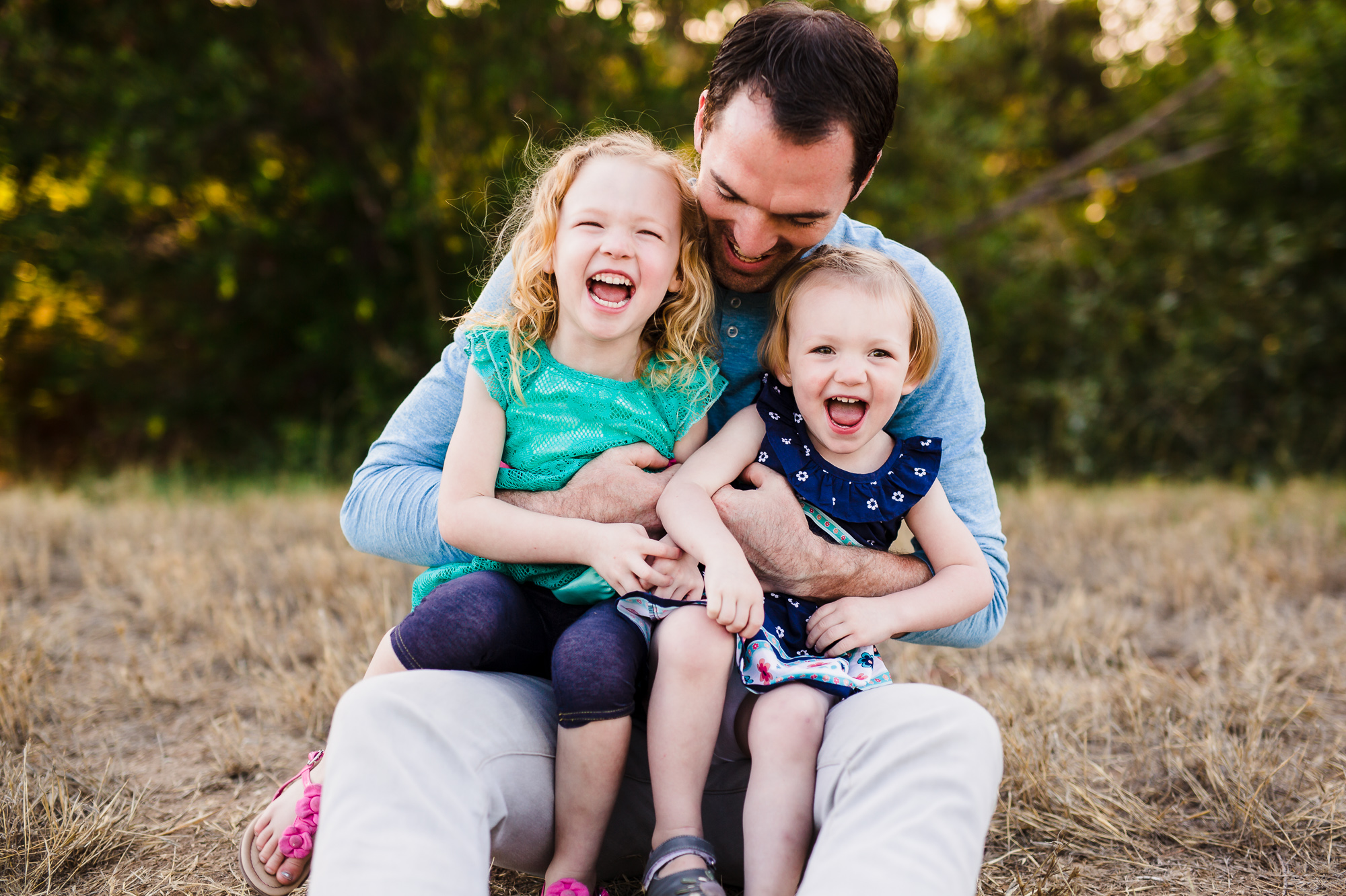 Father plays with two children