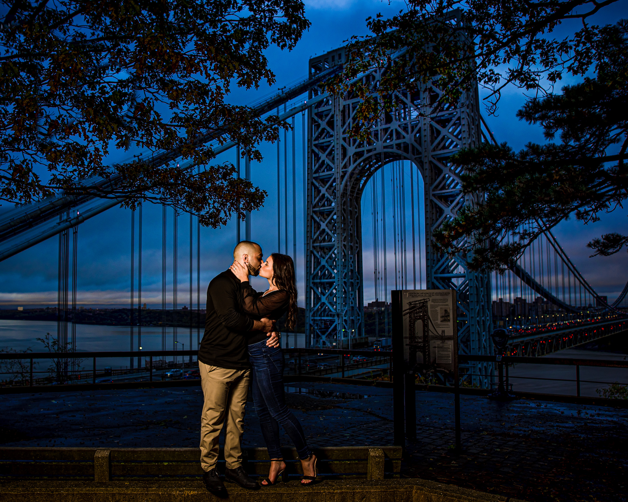Environmental portrait by Matt Gruber showing a balanced composition where the couple is closer and larger in the frame while still showing significant environmental context and using a MagBox to separate the subjects from the background