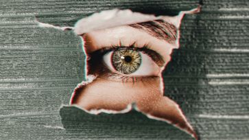 eye photography tips feature eye looking through ripped paper