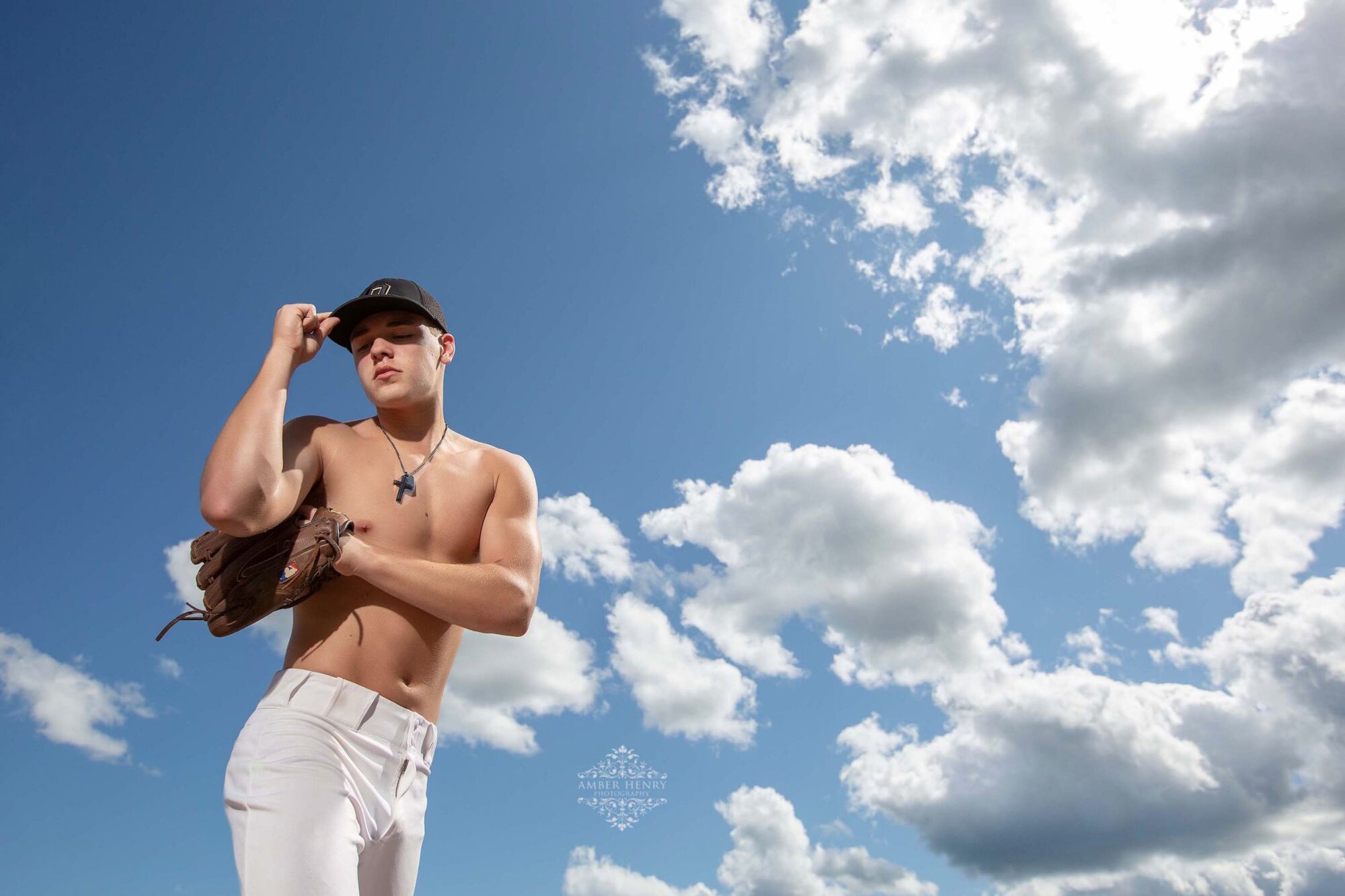 Male baseball senior portrait in action stance with bat