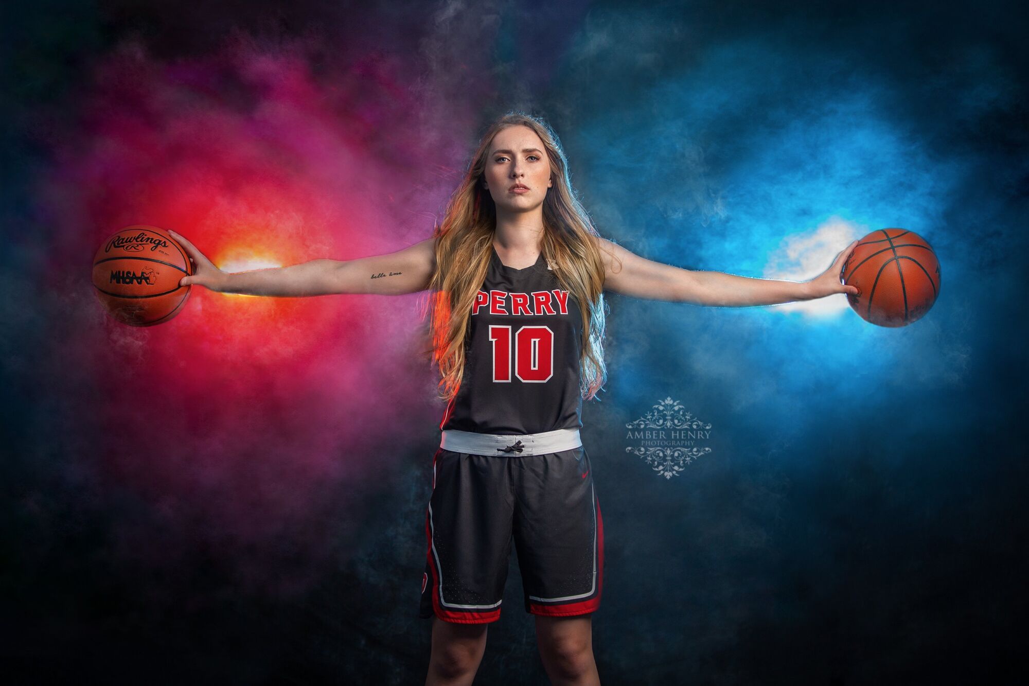 Basketball senior portrait dribbling on an indoor court