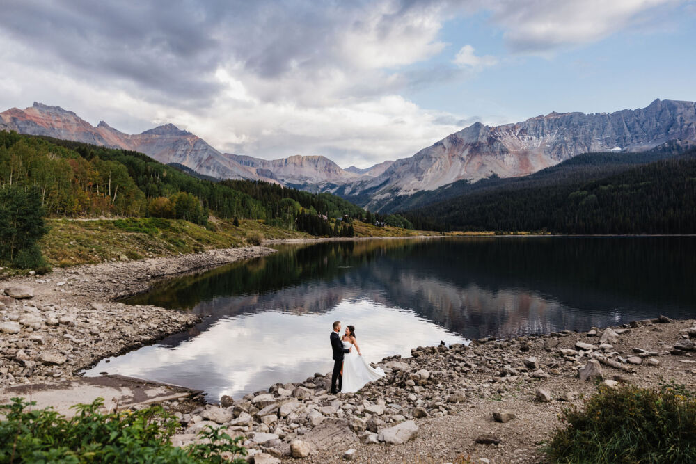 lake wedding photography reflection highlighting a newlywed couple