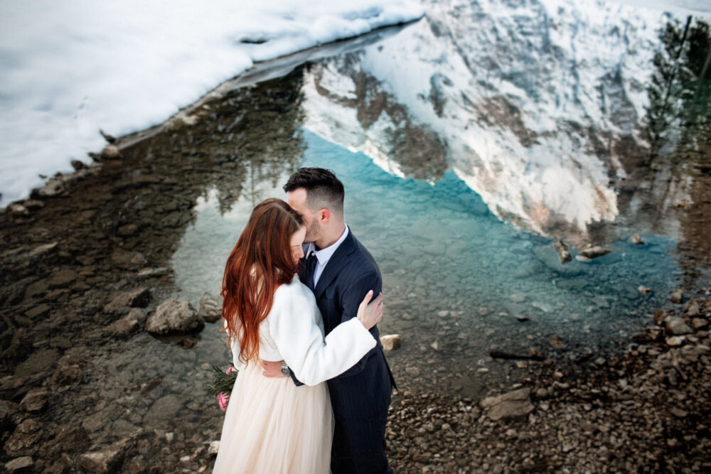 mountain in reflection behind couple