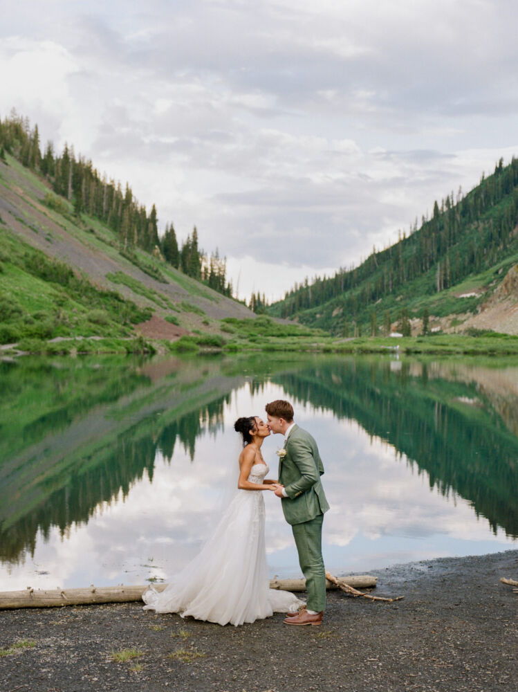 Couple is framed by reflection for lake wedding photography