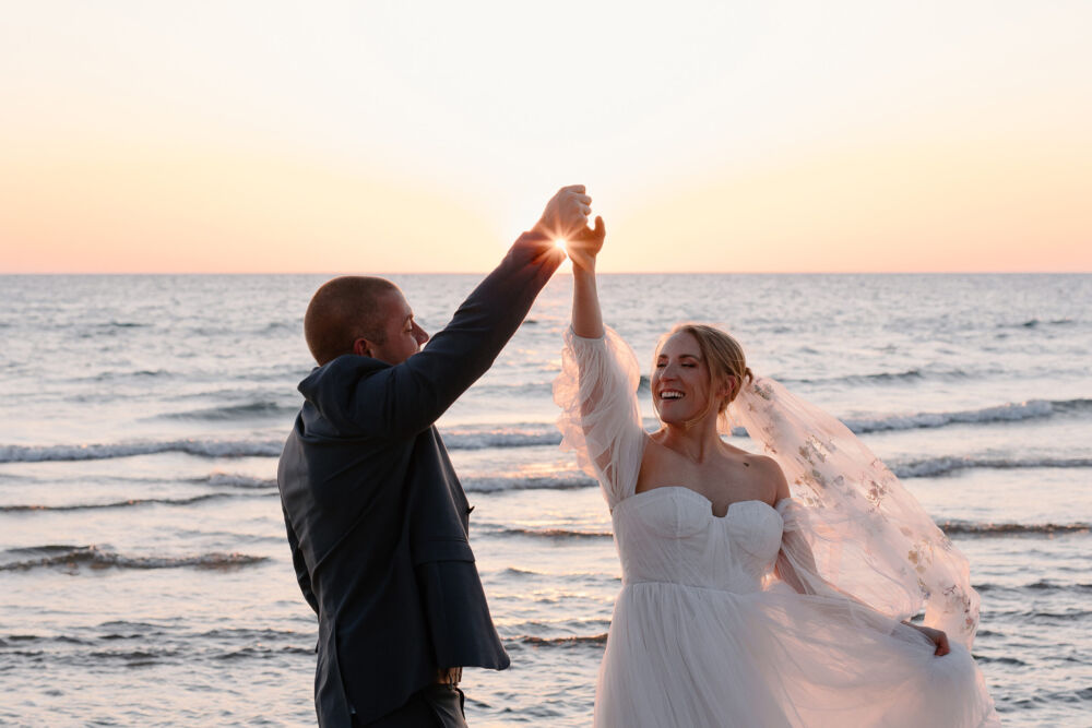 couple high-fives with sun flare