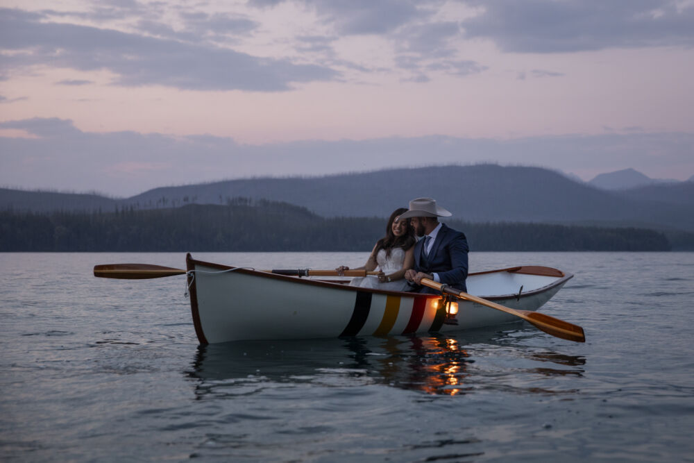couple rows boat after sunset
