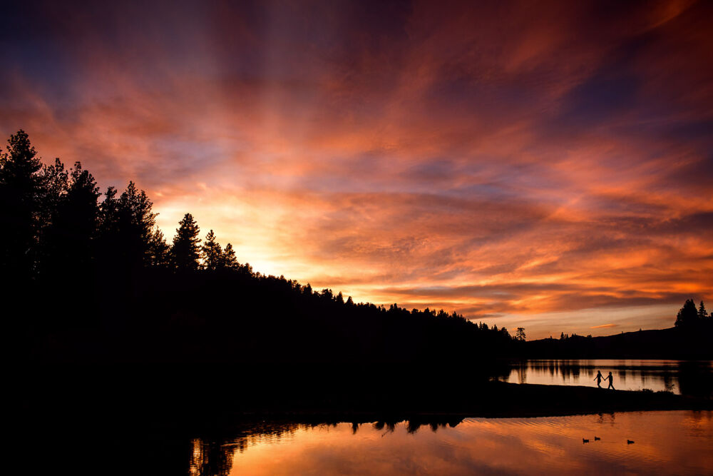 couple silhouetted in epic environmental lake wedding photography portrait
