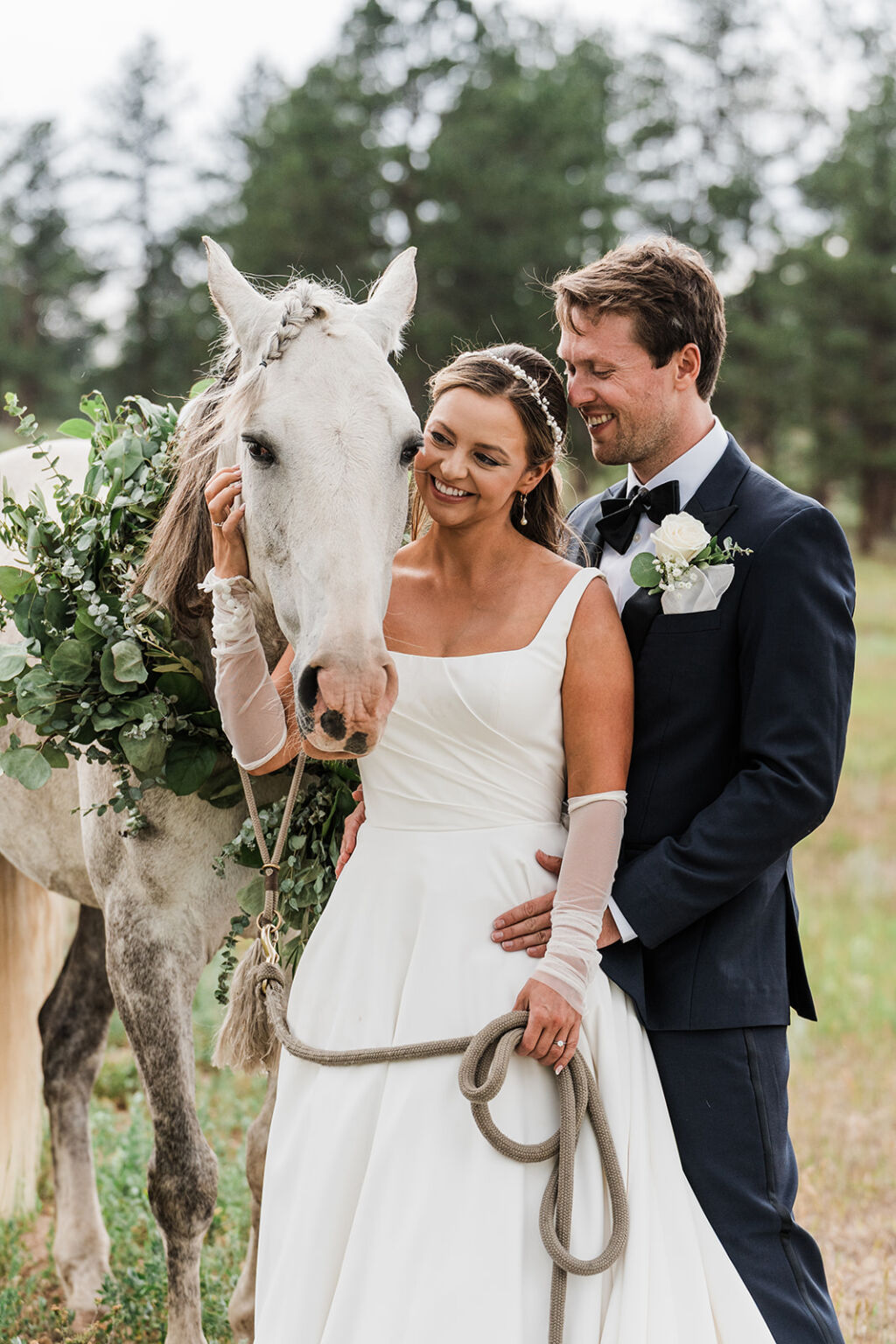 Couple stands near horse for rustic boho weddings